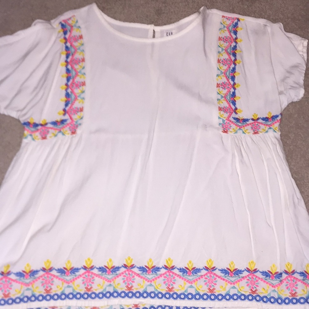 A white flowered detailed blouse for girls